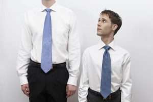 1 Short business man standing next to tall man 300x200 - 1_Short-business-man-standing-next-to-tall-man
